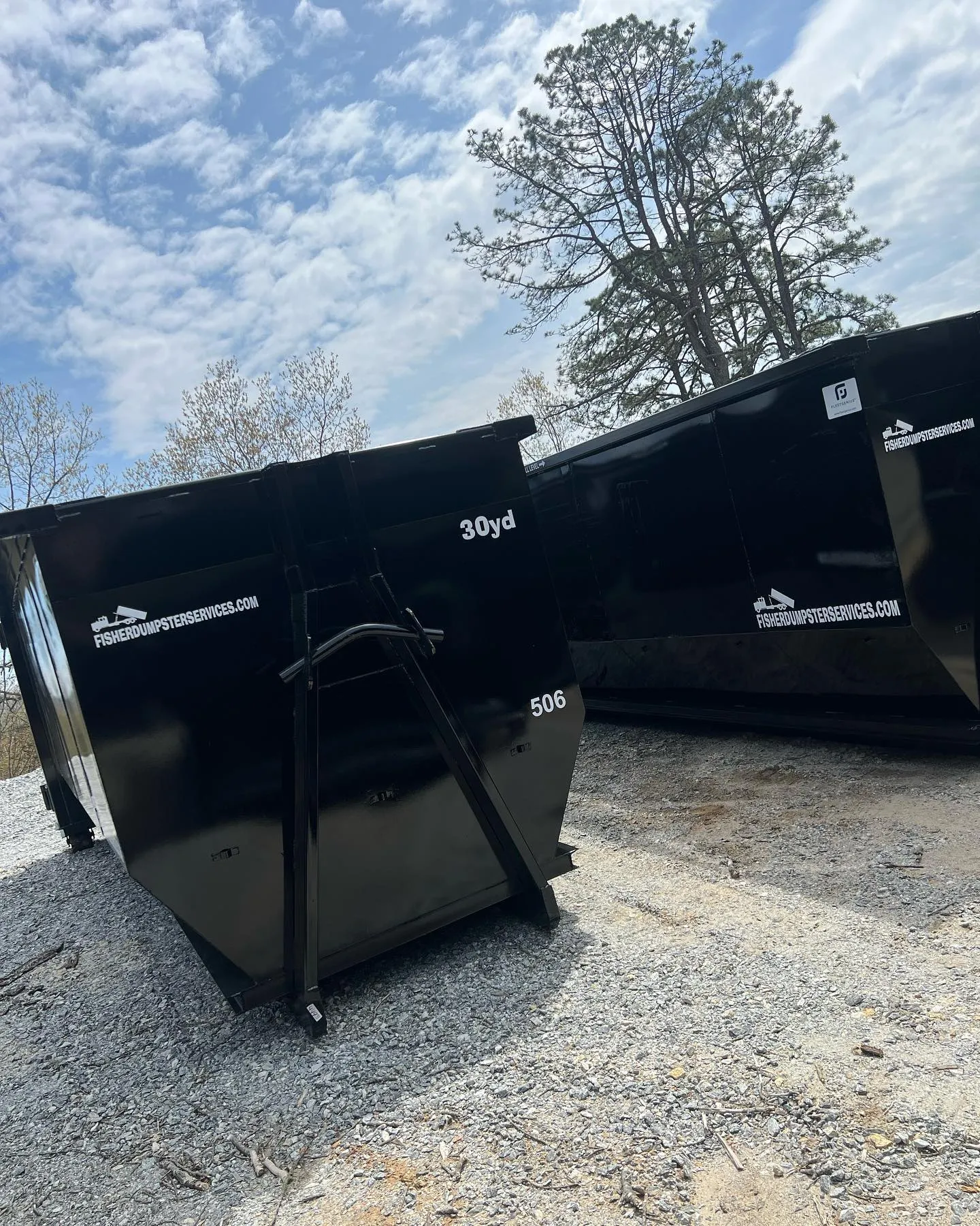 Two Fisher Dumpster Services dumpsters ready for delivery