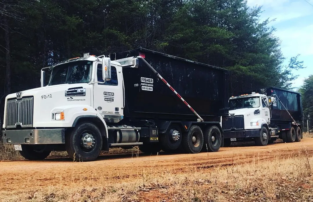 Two Fisher Dumpster Services trucks ready for delivery across Haywood County NC